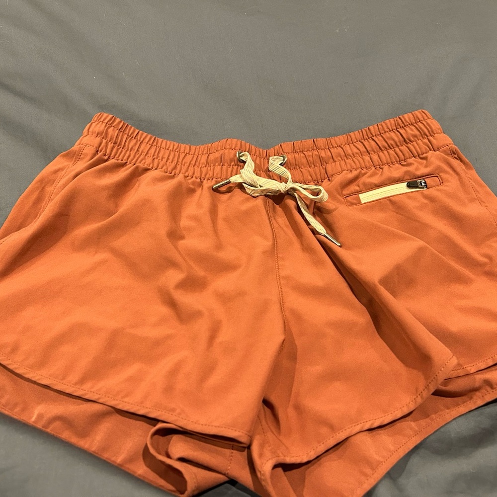 Vuori Women's Athletic Shorts in Rust Orange